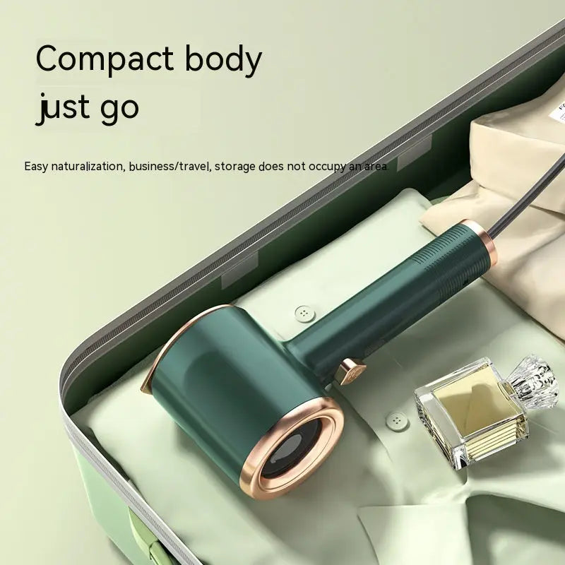Mini handheld garment steamer in green color for travel and home use